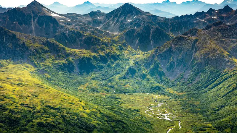 Illustrative photo: Aerial view of green mountains around a steep river valley