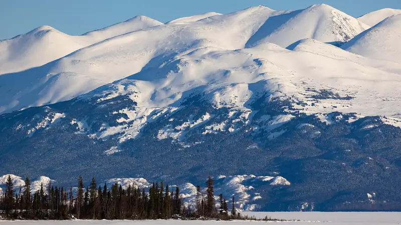 Illustrative photo: Snow-covered Kenai Mountains across frozen Skilak Lake
